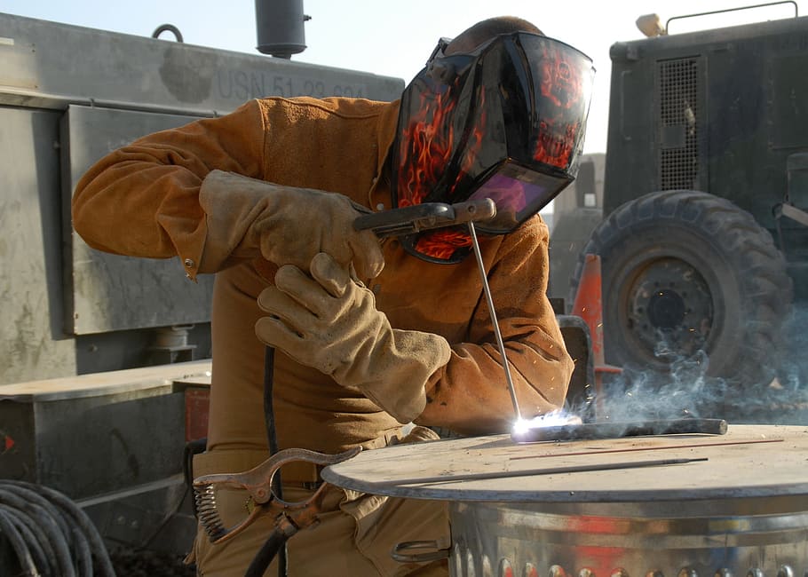 person, wearing, orange, safety gear, black, welding helmet, construction, welding, welder, industry
