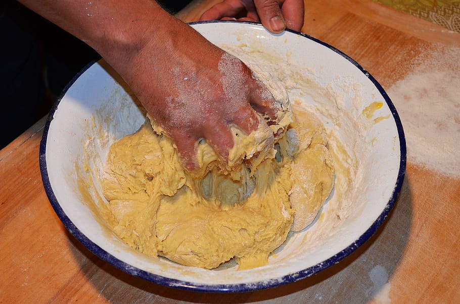 person mixing dough, cake yeast, kneading dough, the bowl, chałka, bread, cake, cakes, raisins, bun