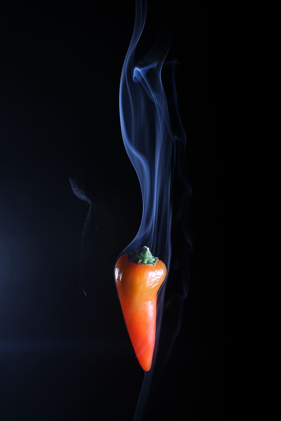 red hot chilli, smoking chilli, hot food, black background, studio shot, indoors, close-up, orange color, burning, food