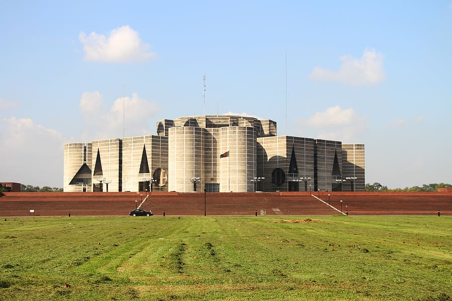 brown concrete building, bangladesh, flag, parliament, architecture, built structure, sky, building exterior, grass, cloud - sky