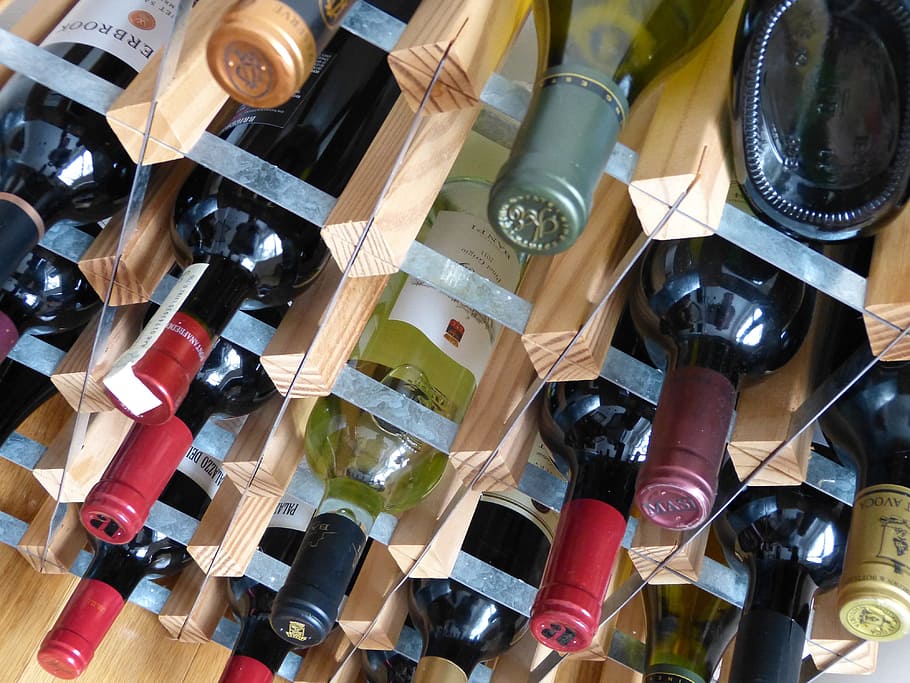assorted-label wine bottle lot, wine, bottles, bottle, glass, white wine, red wine, wine bottle, rack, large group of objects