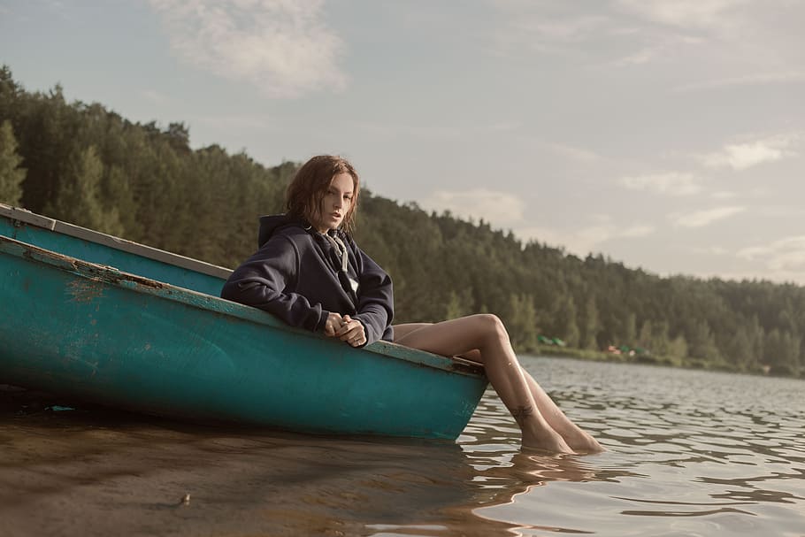 woman, black, jacket, sitting, green, boat, trees, daytime, woman in black, on the edge