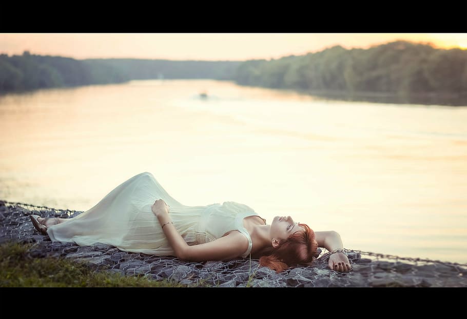 selective, focus photography, woman, laying, ground, body, water, wearing, white, sleeveless