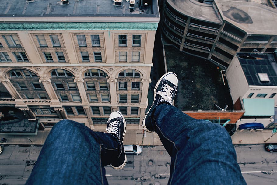 buildings, city, sneakers, people, edge, rooftop, travel, low section, human leg, one person