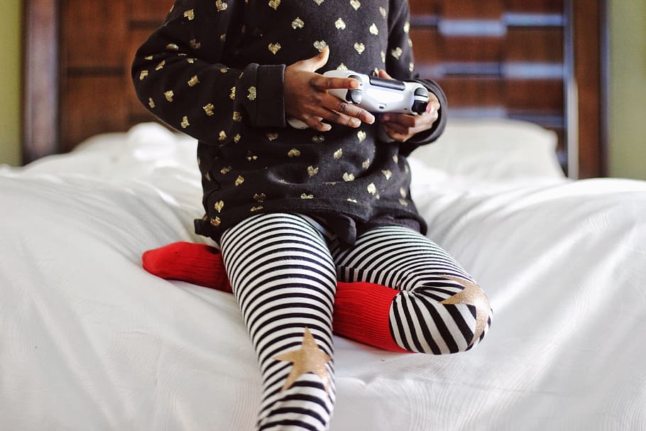 child, playing, games, bedroom, joystick, star, stripe, socks, bokeh, bed