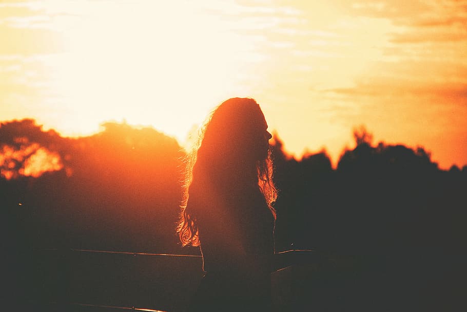 silhouette, woman, standing, facing, right, sunset, sun rays, dusk, shadow, girl