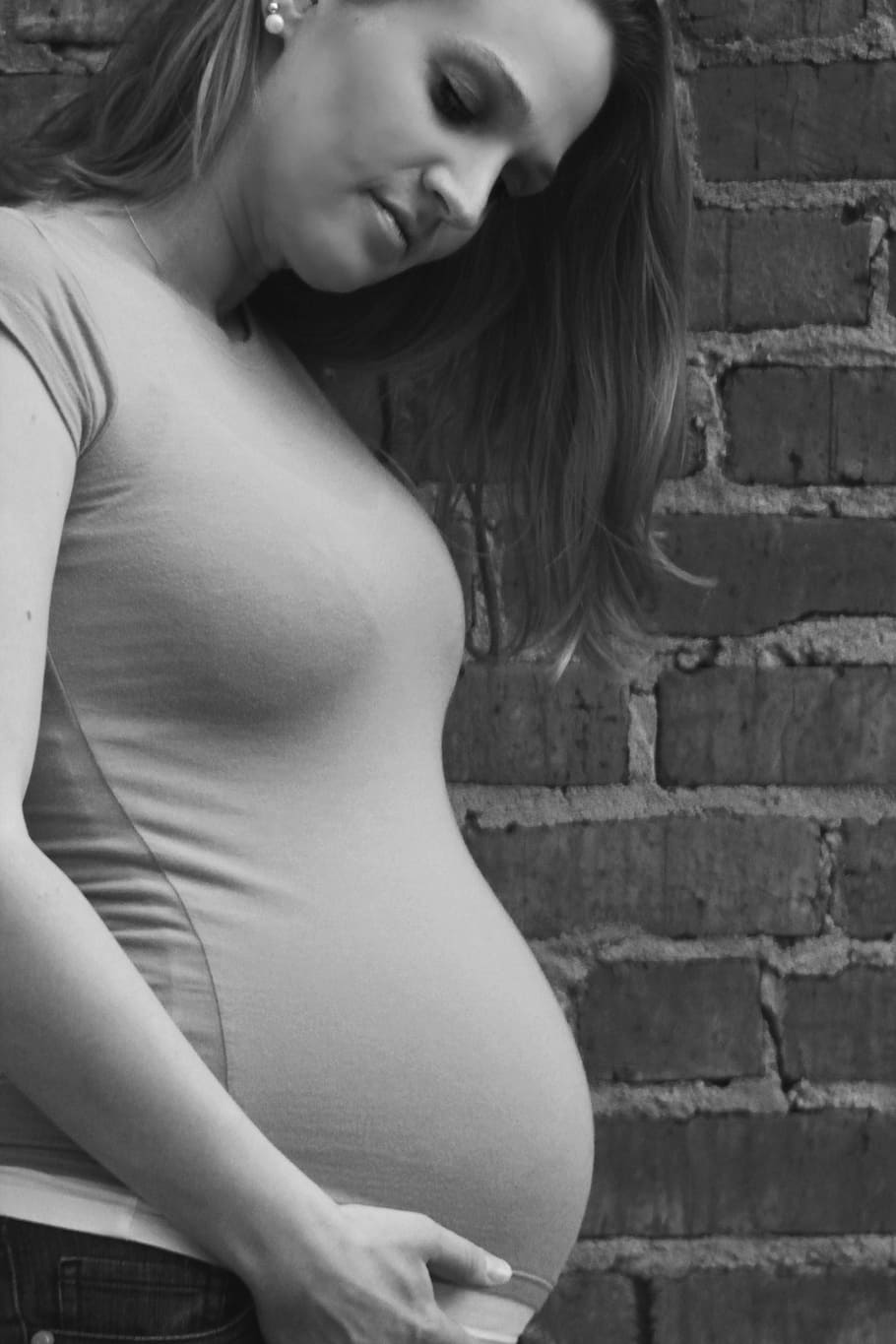 greyscale photo, woman, pregnancy, bump, concrete, brick wall, pregnant, baby, belly, mother