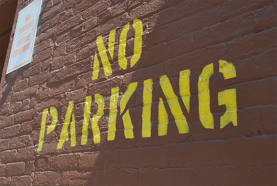 no parking, sign, bricks, wall, text, communication, wall - building feature, architecture, built structure, yellow