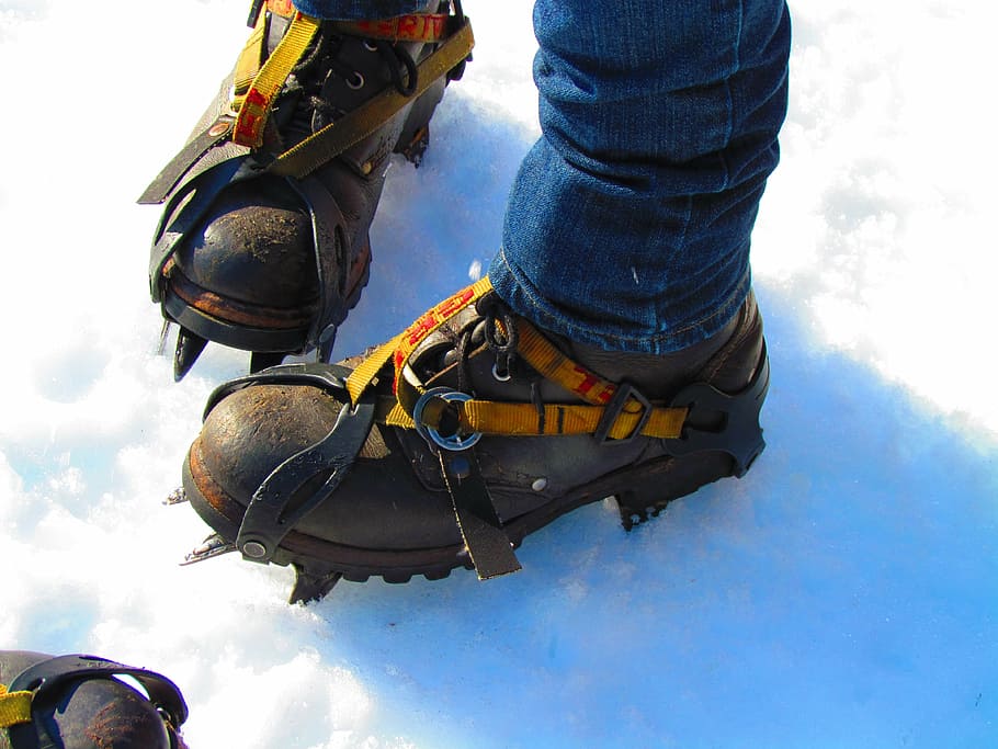 person, wearing, black, ice boots, hiking, shoes, ice spikes, glacier, snow, feet