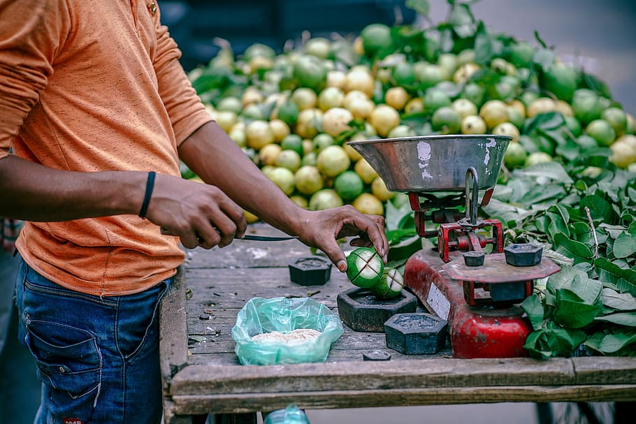 people, man, market, vendor, fruits, green, weighing scale, wood, table, one person
