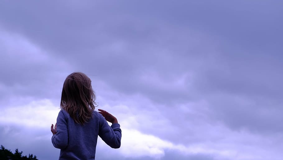 girl facing sky, person, gray, shirt, starting, cloudy, sky, blue, cloud, kid