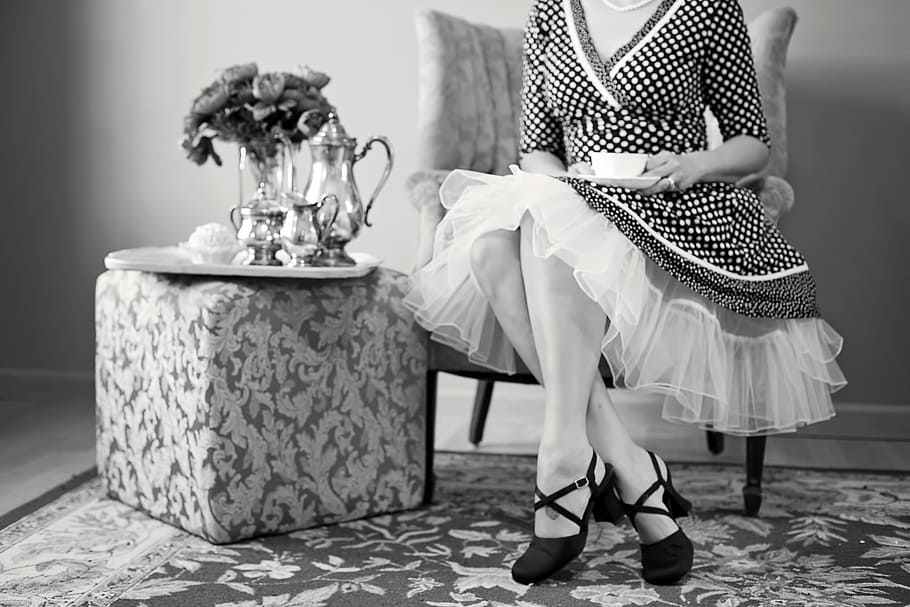 grayscale picture, woman, sitting, next, end table, tea party, tea, black and white, teapot, drink