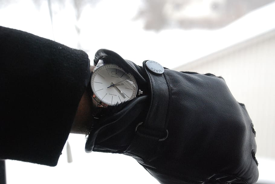 person, wearing, black, leather glove, round, analog, watch, displaying, 2:22, mittens