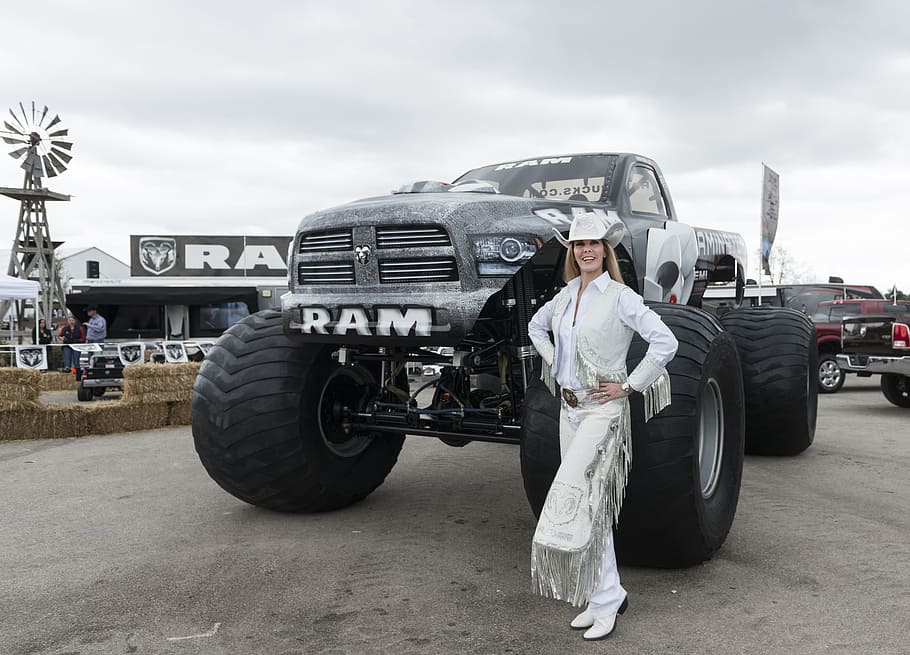 smiling, woman, standing, front, black, dodge, ram, 1500, single, cab pickup truck
