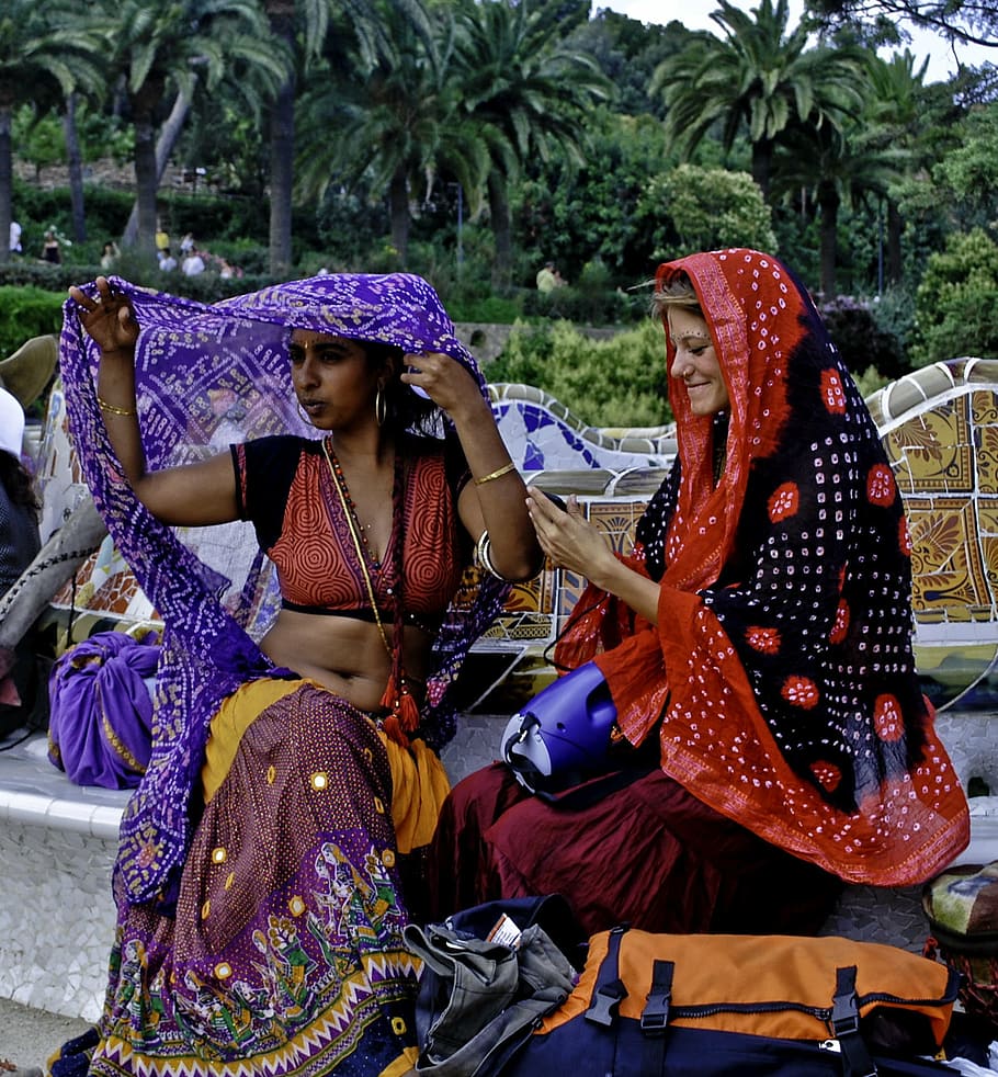 two, women, wearing, assorted-color shawls, o, barcelona, sitting, shadow, sun, daylight