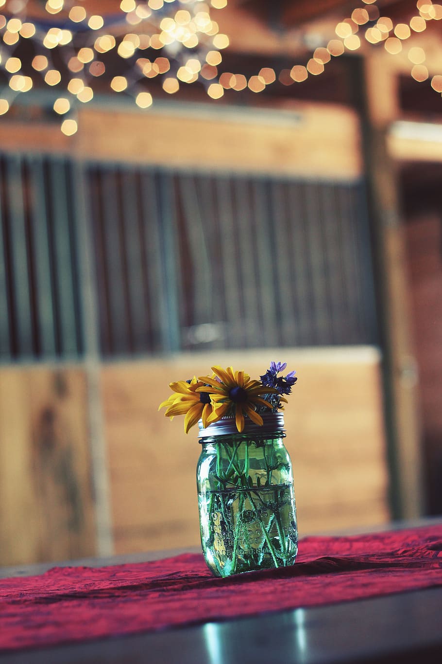 glass, jar, container, water, flowers, display, interior, table, bokeh, focus on foreground