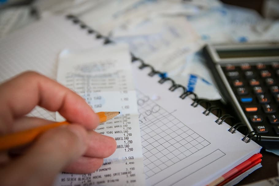 person, holding, pencil, receipt paper, money, bills, calculator, save, savings, taxes