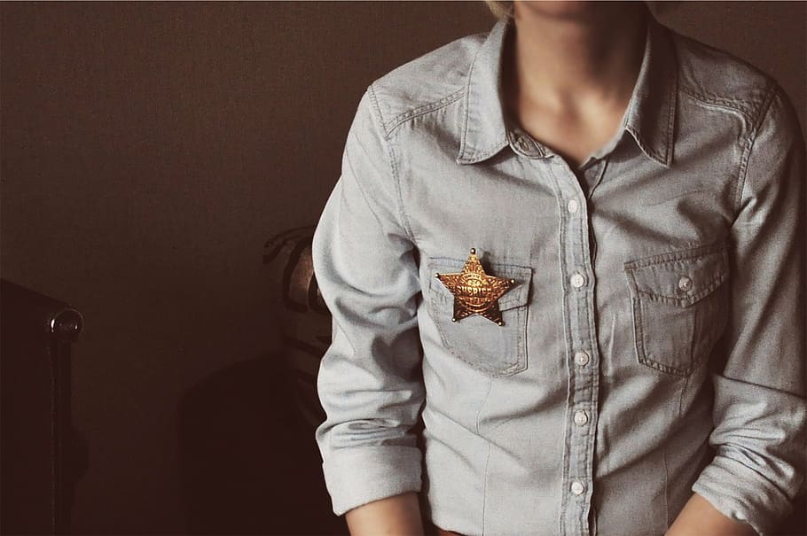 person, wearing, gray, button-up shirt, button, shirt, sheriff, star, denim, one woman only