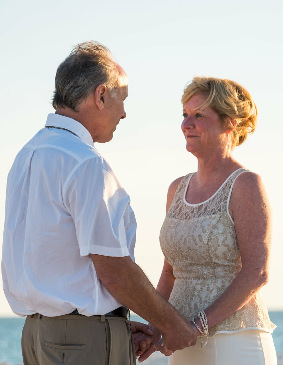 selective, focus photography, man, woman, standing, holding, hands, daytime, beach wedding, happy couple