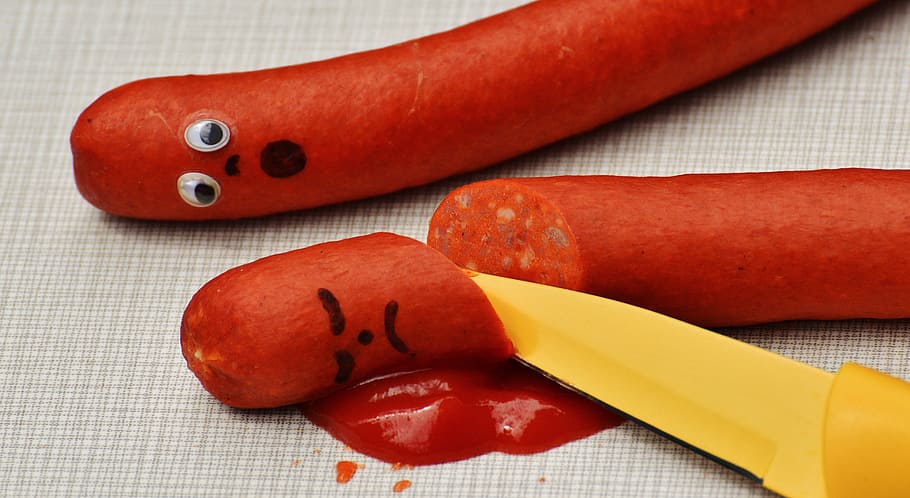 two red saugages, sausage, ketchup, murder, blood, funny, fun, knife, food, hearty