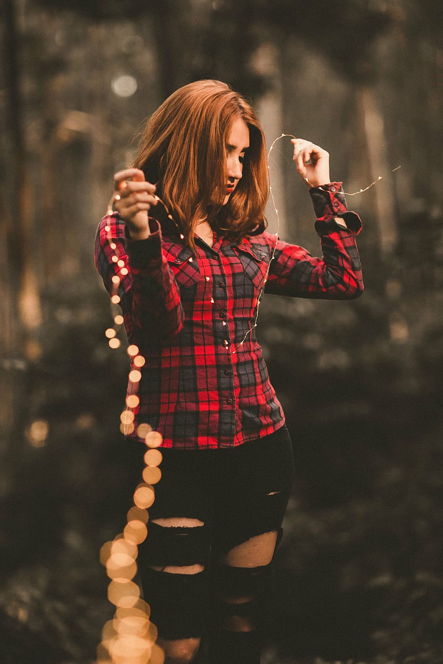 woman, holding, yellow, string lights, people, girl, ripped, jeans, ripped jeans, outdoor