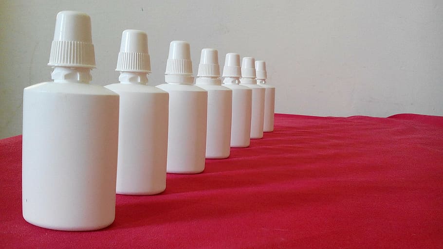 several, white, plastic bottles, red, cloth, collection, spray, nasal, nose, medical