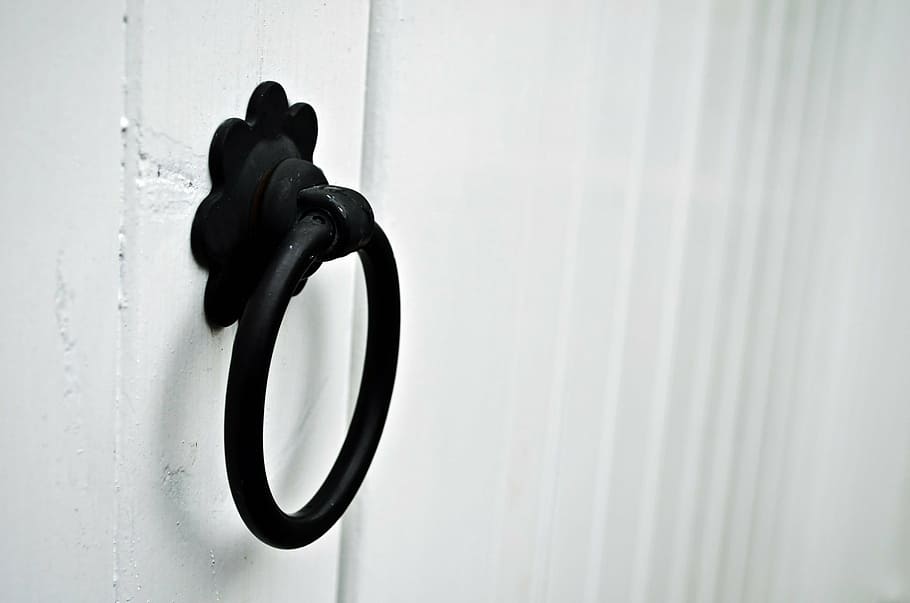 black, steel ring door knocker, white, wooden, wall, art, artistic, iron, decorative, detail
