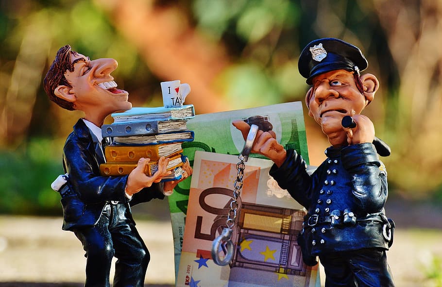 two, blue-and-beige, ceramic, officeman, policeman figurines, selective, focal, taxes, tax evasion, police