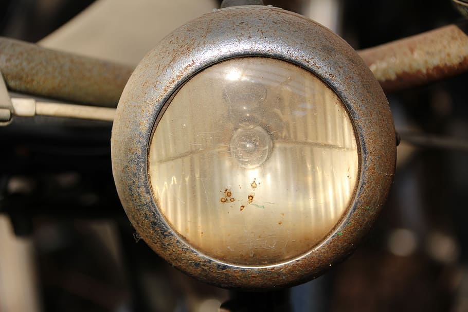 bike, front light, lighting, metal, focus on foreground, close-up, rusty, old, machinery, indoors