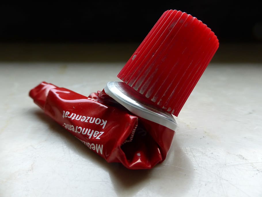 tube, toothpaste, aluminium, red, empty, depleted, depressed, rolled, lid, screw lid
