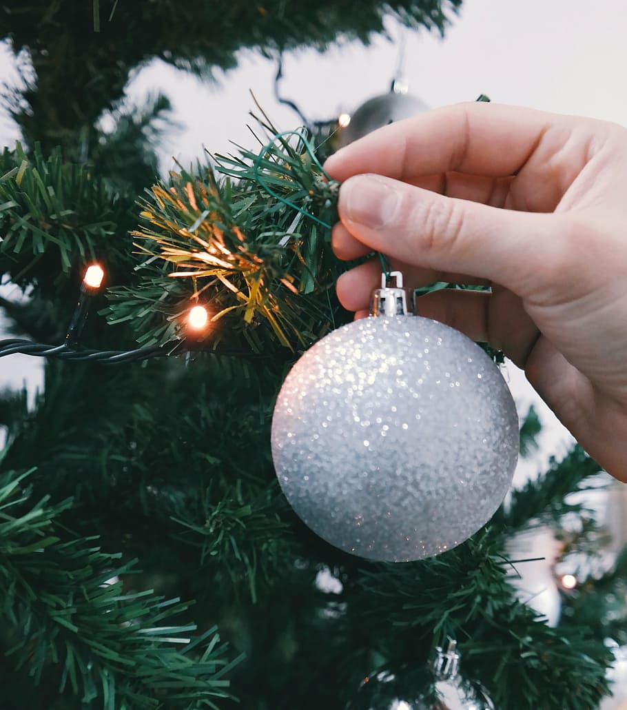 gray glitter baubles, person, holding, grey, bauble, green, plastic, tree, turned, yellow