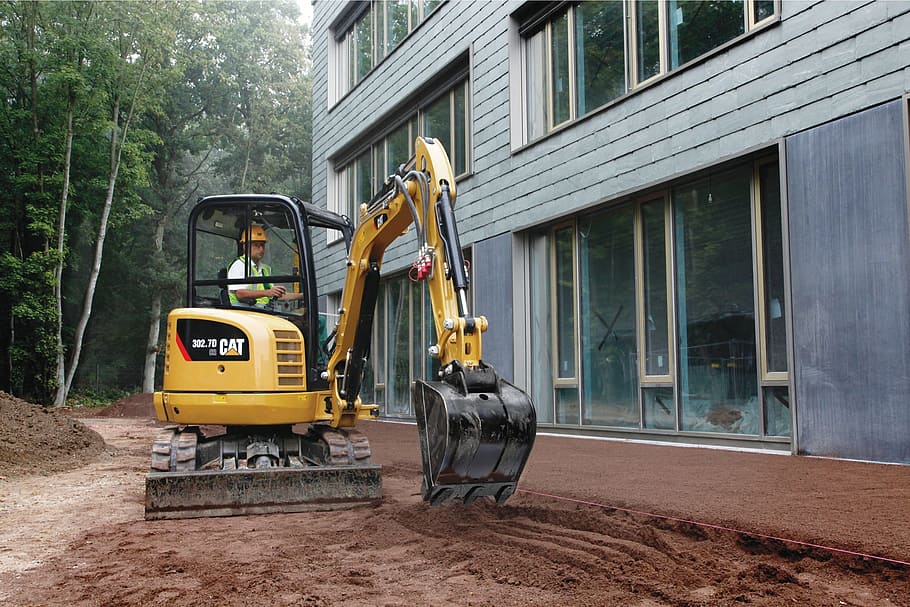 man, using, black, yellow, excavator, cat, 302, 7d, mini excavator, caterpillar