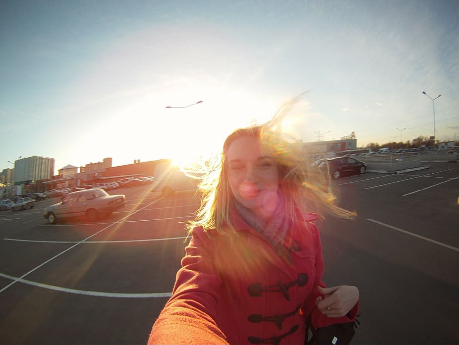 woman, taking, selfie, walking, parking lot, vehicle, sunlight, girl, blonde, portrait