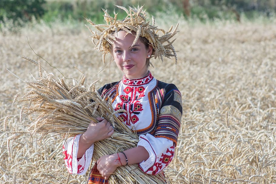 woman, wearing, white, red, long-sleeved, dress, holding, bunch, wheat barley, Harvest