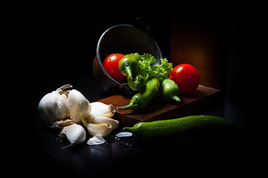 assorted vegetables photography, dark mood food, vegetables, lichtspiel, rembrandt light, garlic, pepperoni, sharpness, sharp, food