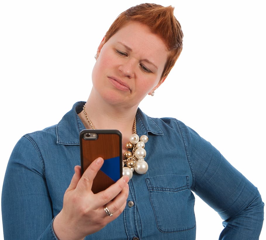 woman, wearing, blue, chambray shirt, holding, smartphone, poses, elearning, female, girl