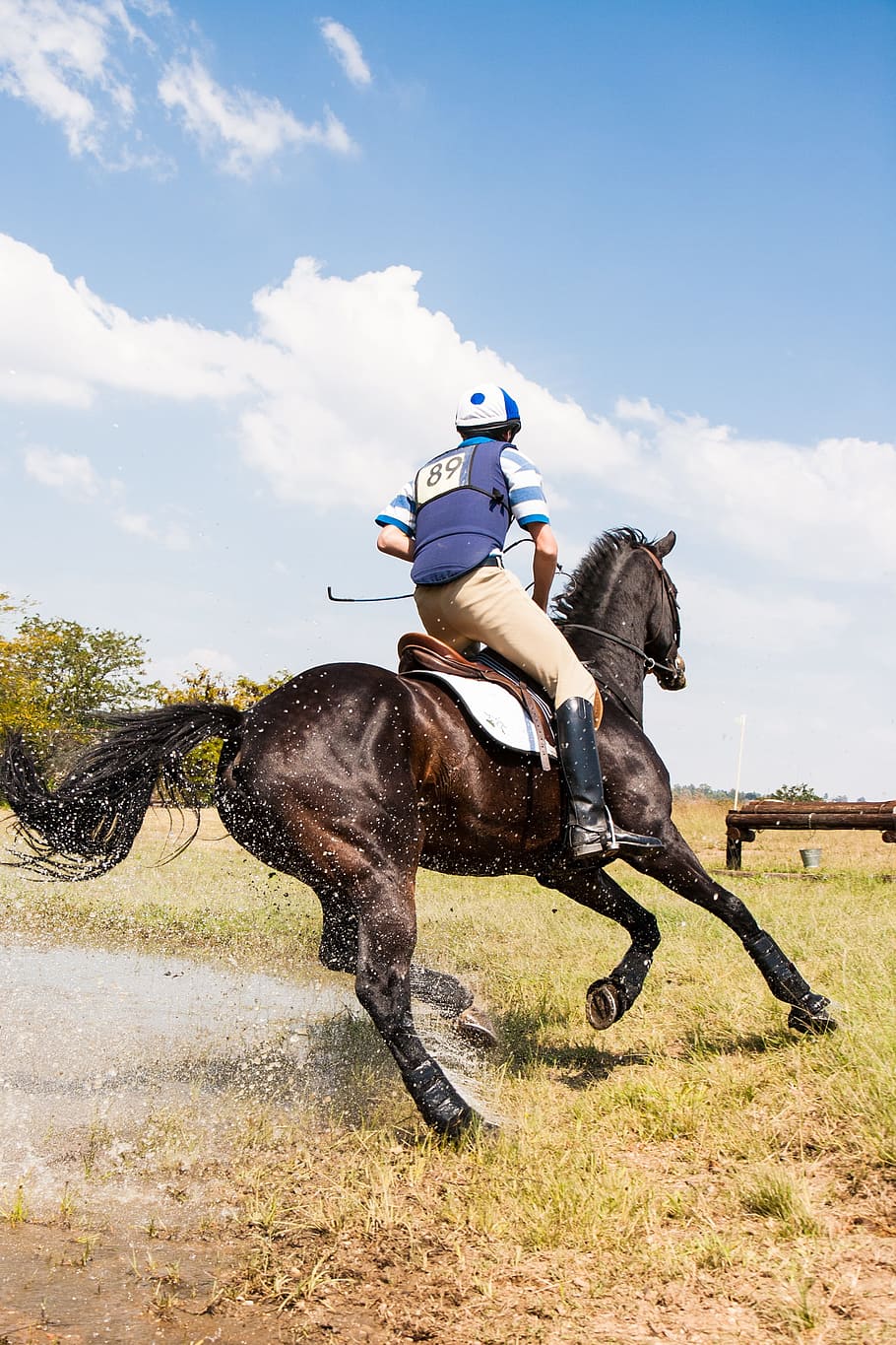 man, riding, horse, horse and rider cornering at speed, water jump, eventing, three day event, cross country, equestrian, rider