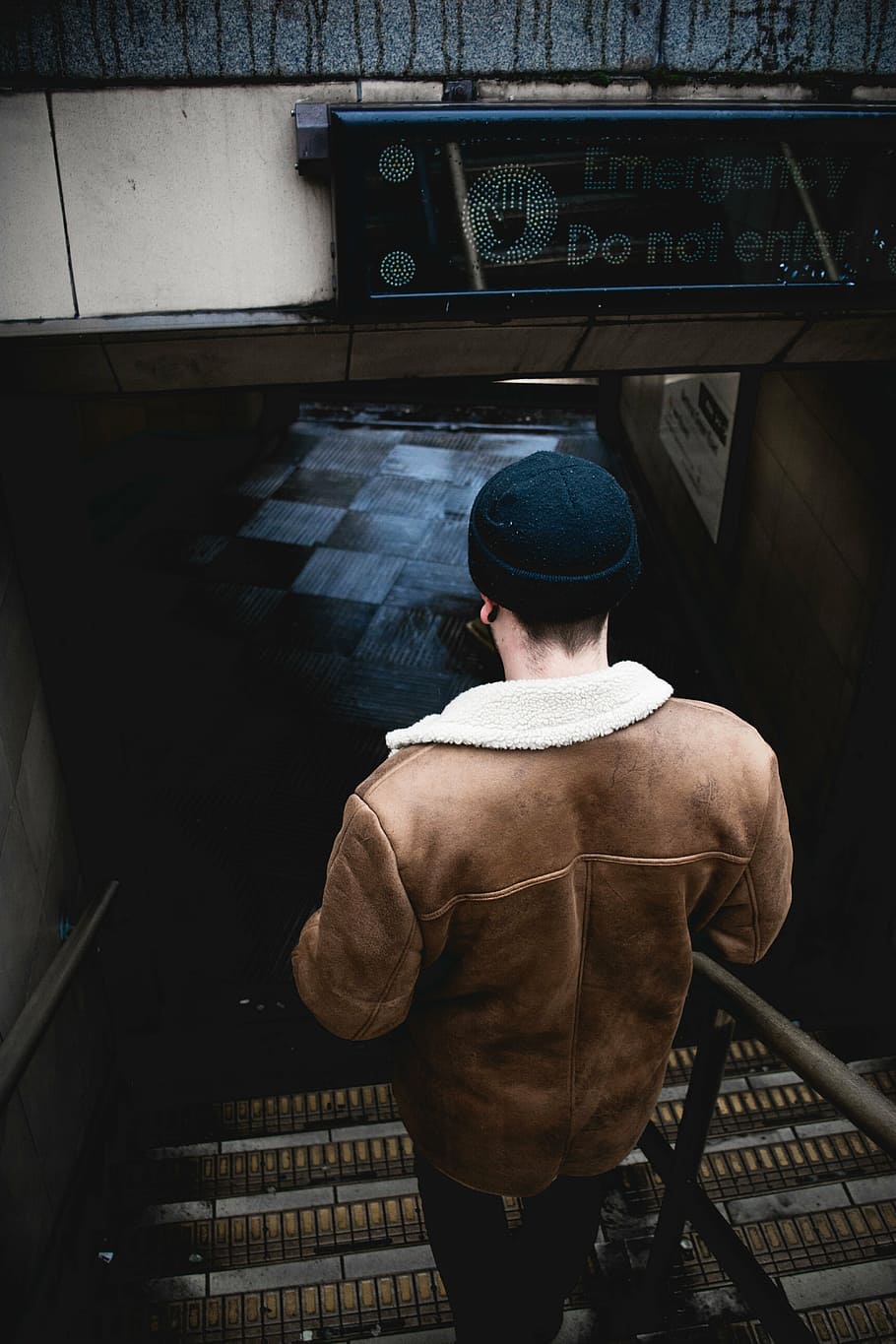 man walking downstairs, beanie, back, guy, man, people, stairs, floor, checkered, leather