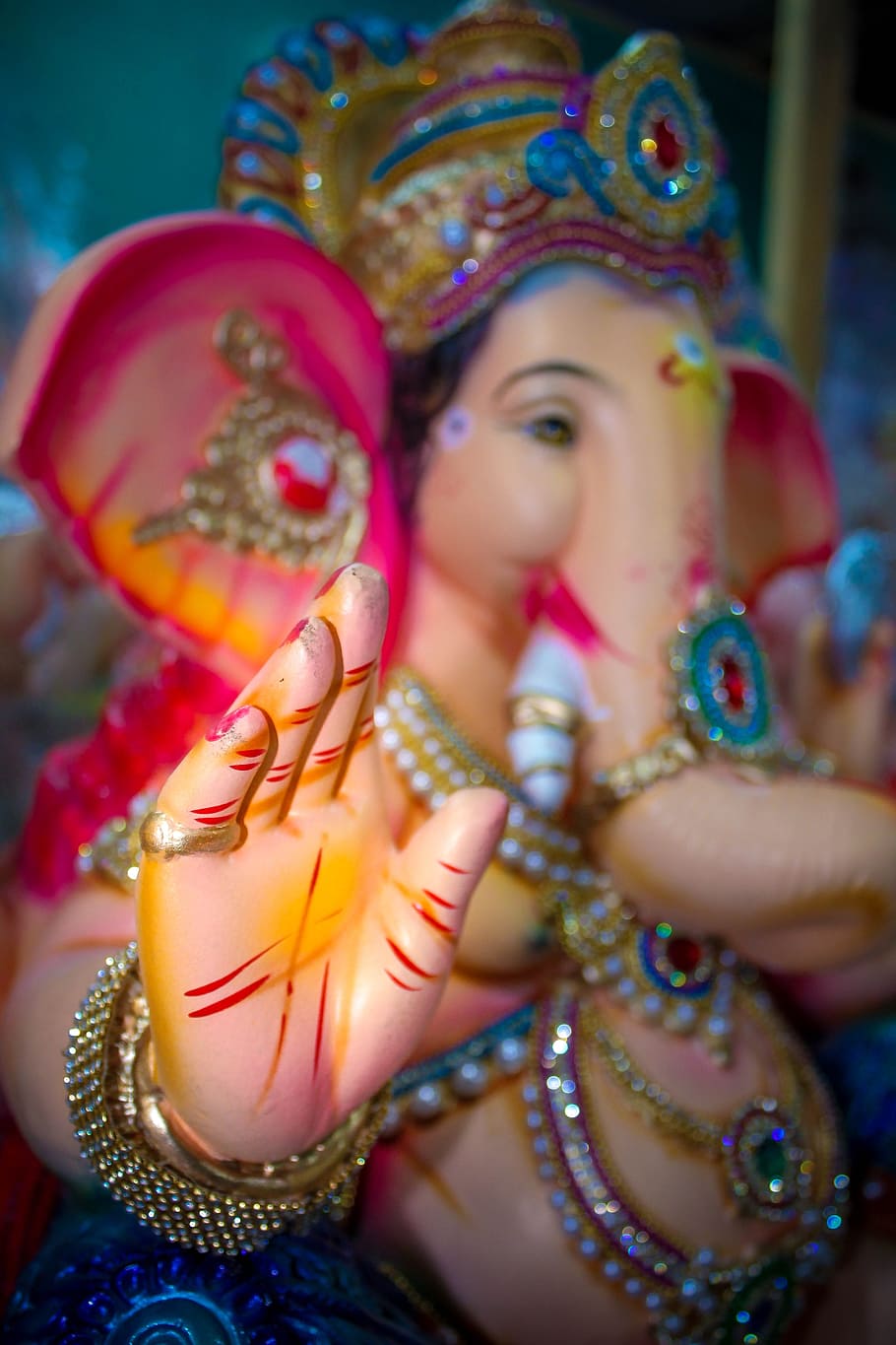 lord ganesha figurine, lord ganesh, lord ganesha, hinduism, one person, portrait, women, traditional clothing, focus on foreground, celebration