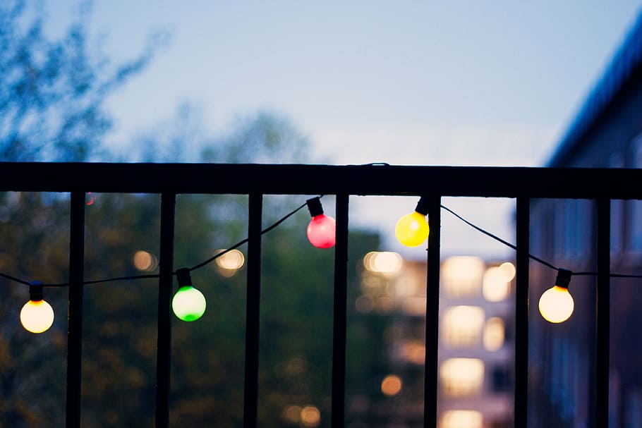 close-up photo, black, metal railings, sky, lights, bulb, electricity, bokeh, blur, outdoors