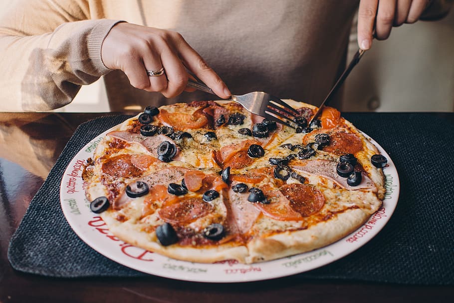 person, slice pizza, plate, pizza, food, cheese, crust, pepperoni, olives, fork