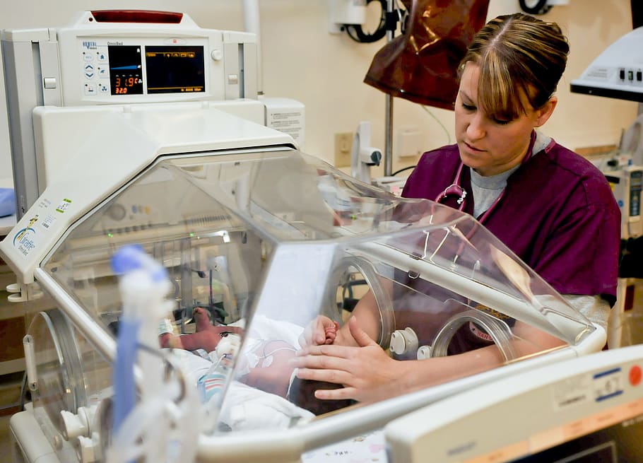 woman, touching, baby, inside, incubator, hospital room, nurse, military, child, real people