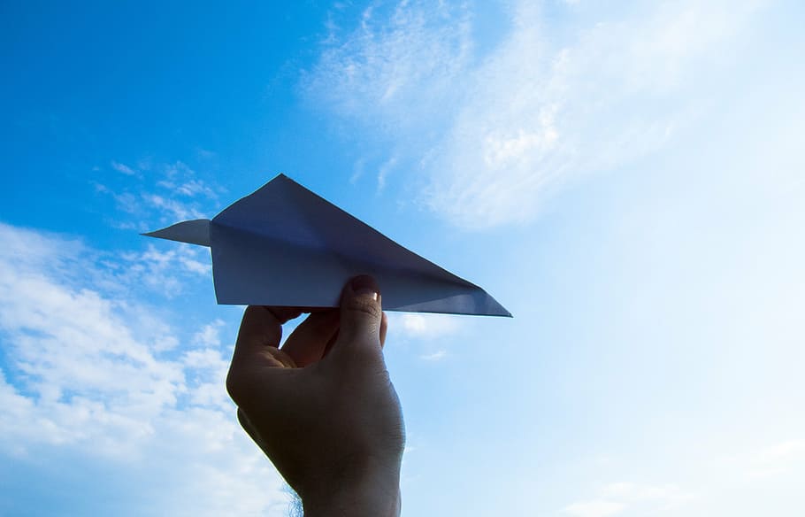 person, holding, paper plane, daytime, the hand, sky, throw, clouds, paper, the plane