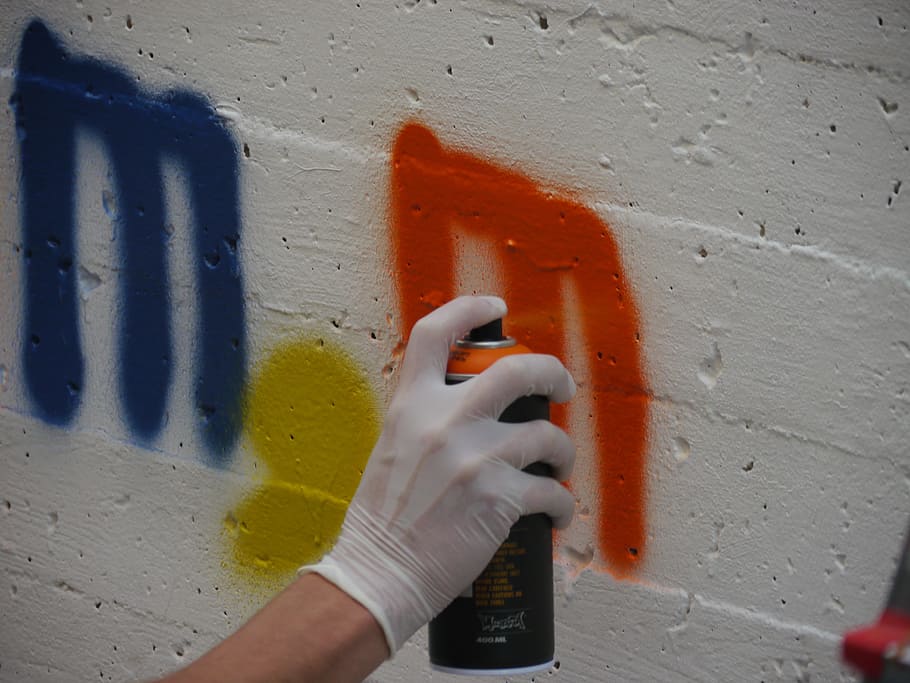 graffiti, box, s, spray can, spray, human hand, hand, human body part, wall - building feature, one person