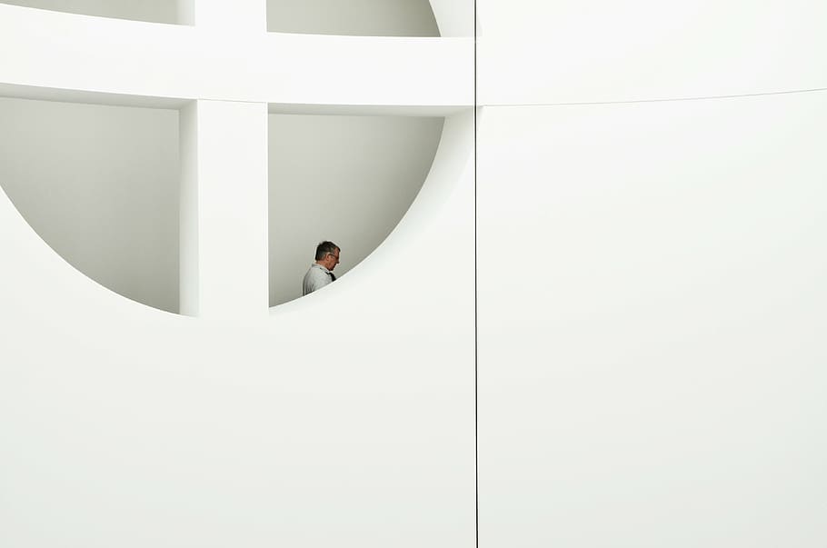 man, standing, window, daytime, white, suit, view, small, hole, wall