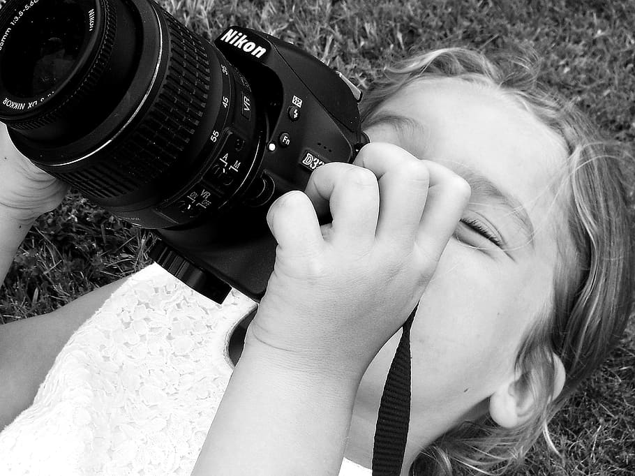grayscale photo, girl, using, camera, child, black and white, device, spontaneous, innocence, joy