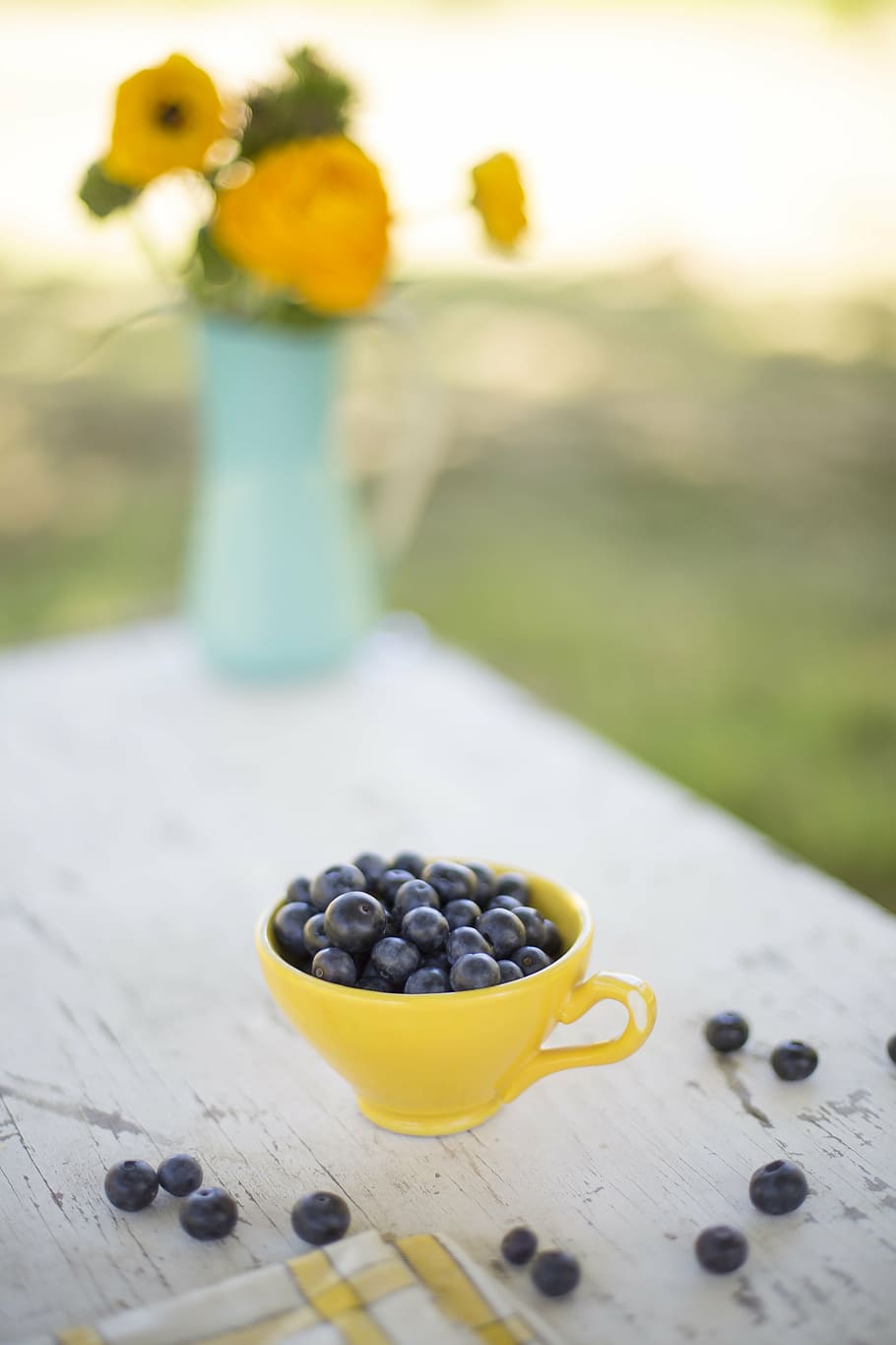 selective, focus photo, yellow, ceramic, teacup, wooden, table, blueberries, bowl, snack