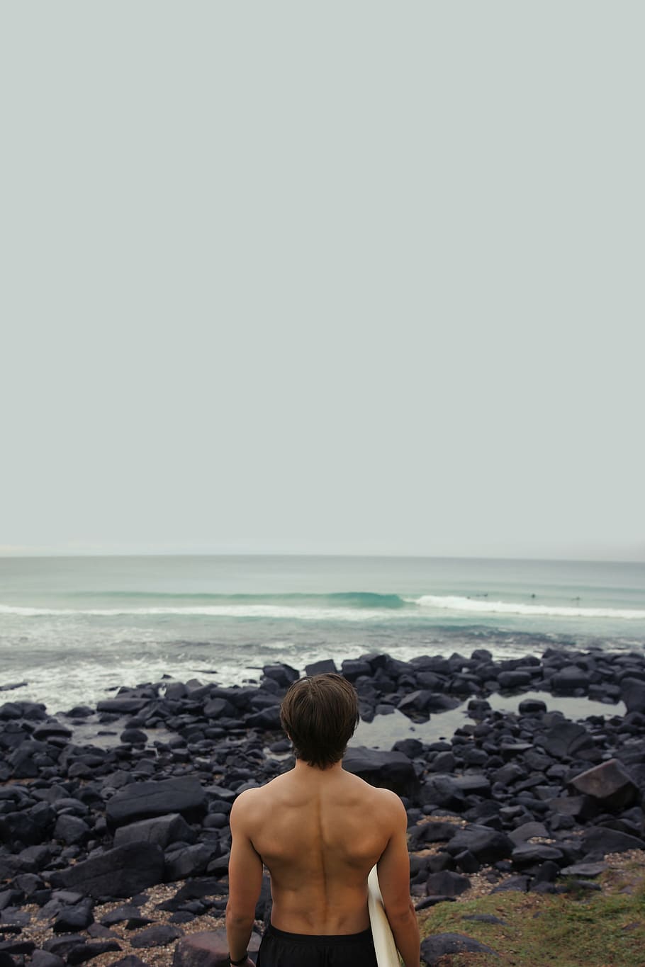 homem, em pé, mar, segurando, prancha de surf, olhando fixamente, corpo, agua, dia, surfista