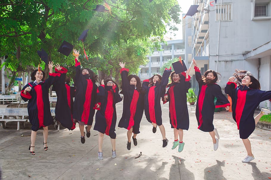 women, wearing, black, pink, academic, regalia, friend, student, graduate, young