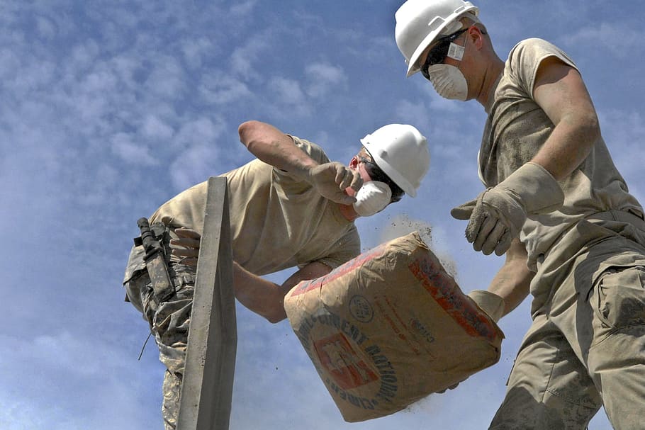 two, person, dropping, sack, cement, construction, work, labor, concrete, building